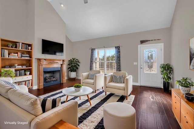 living room with dark hardwood / wood-style floors and high vaulted ceiling