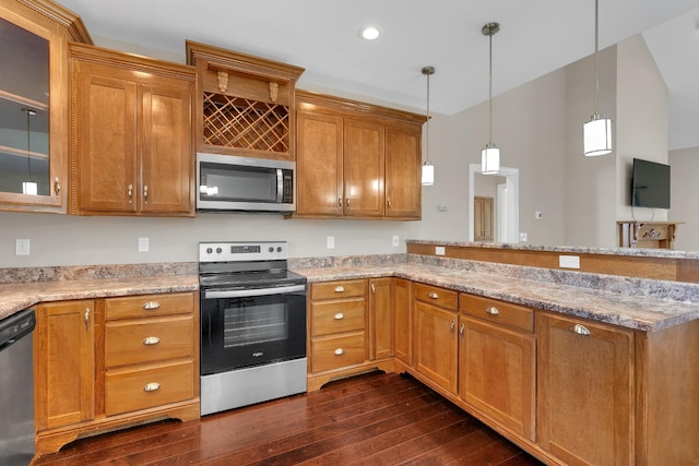 kitchen featuring kitchen peninsula, light stone counters, stainless steel appliances, dark wood-type flooring, and hanging light fixtures