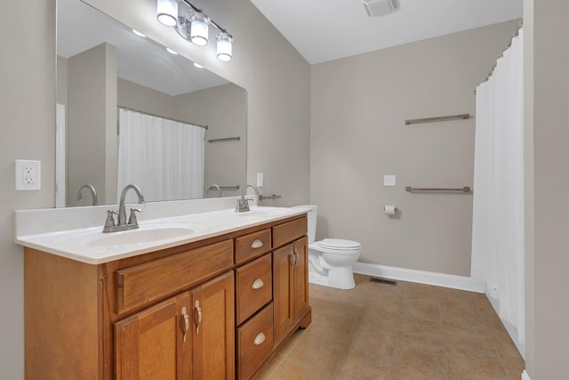 bathroom featuring tile patterned floors, vanity, and toilet