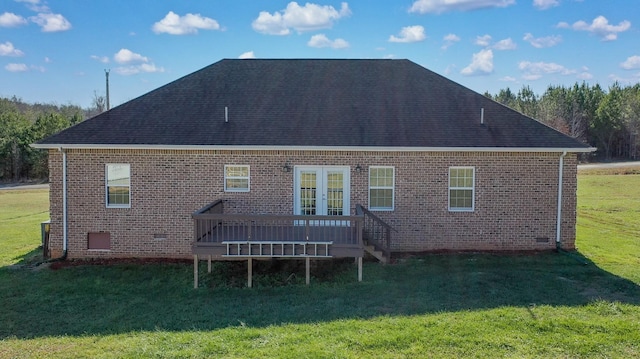 rear view of property with a lawn, french doors, and a deck