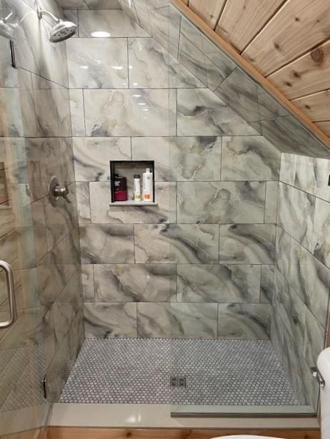 bathroom with toilet, an enclosed shower, and wood ceiling