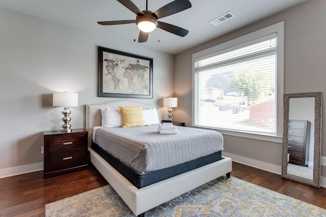 bedroom featuring multiple windows, ceiling fan, and dark hardwood / wood-style flooring