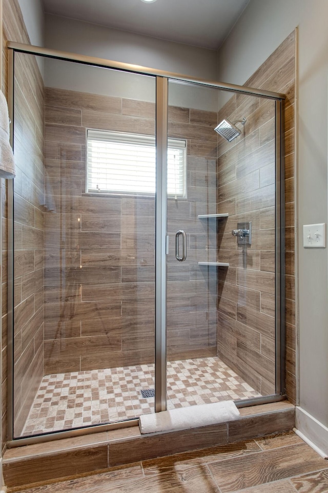 bathroom featuring a shower with shower door