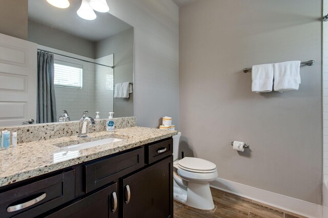 bathroom with vanity, curtained shower, and toilet