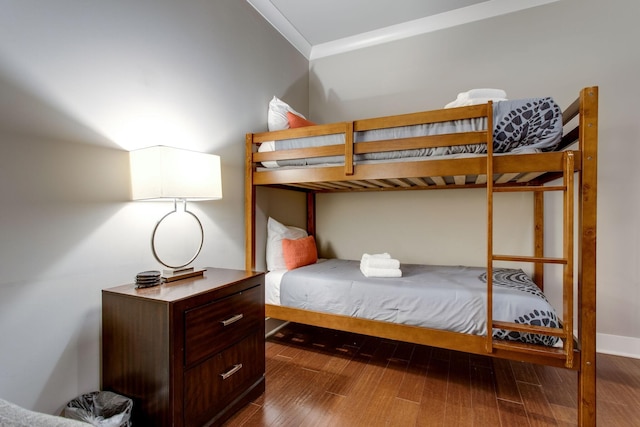 bedroom featuring dark hardwood / wood-style flooring and ornamental molding