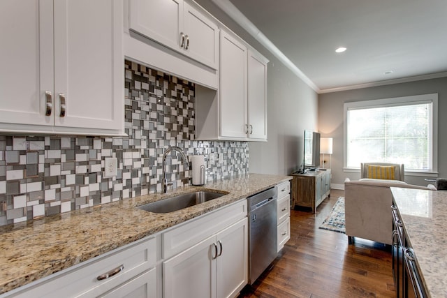 kitchen featuring backsplash, sink, stainless steel dishwasher, light stone countertops, and white cabinetry