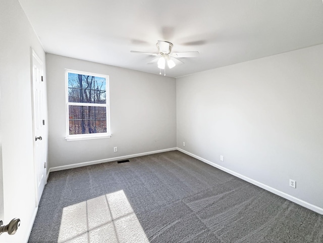 unfurnished room featuring ceiling fan and dark carpet