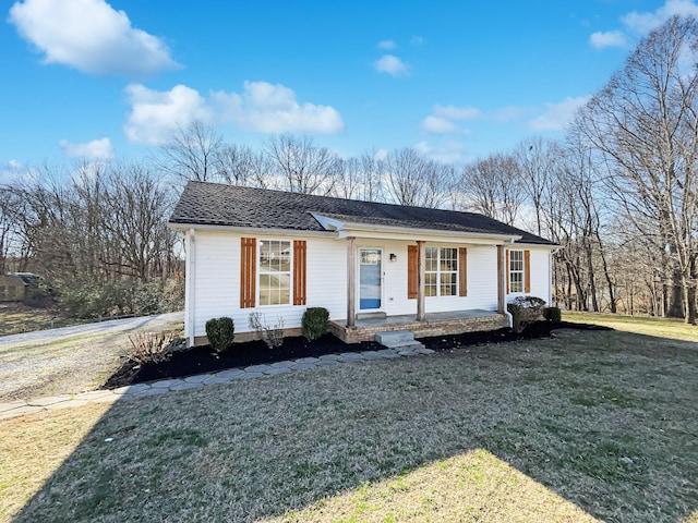 view of front of home featuring covered porch and a front lawn