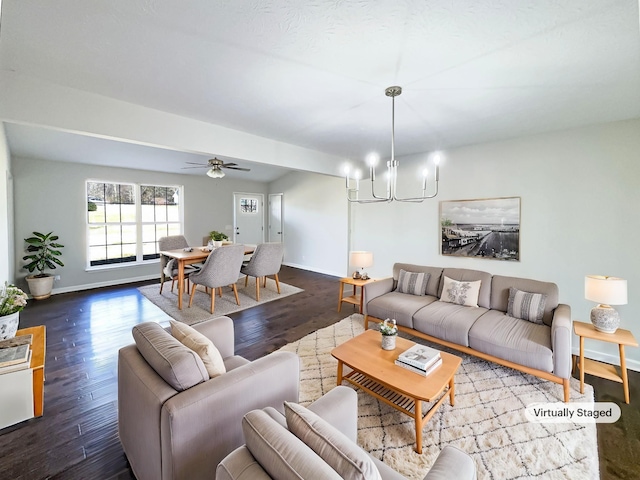 living room with hardwood / wood-style flooring and ceiling fan with notable chandelier