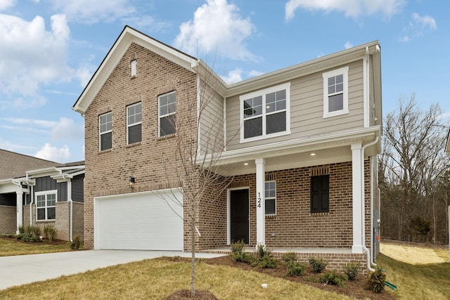 front of property with a garage, a front yard, and covered porch