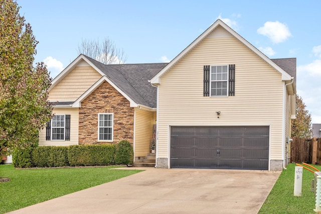 view of property with a front lawn and a garage