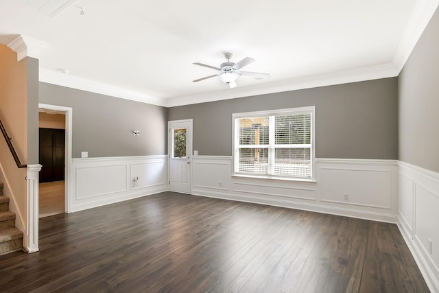 empty room featuring ornamental molding, ceiling fan, and dark wood-type flooring