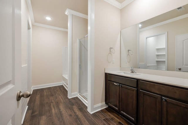 bathroom featuring plus walk in shower, wood-type flooring, and ornamental molding