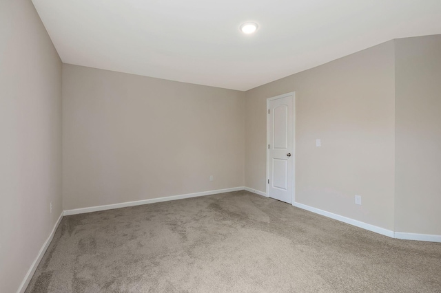 unfurnished room featuring light carpet