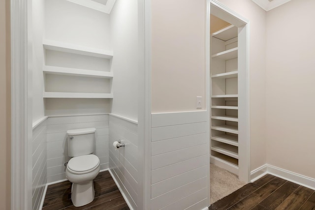 bathroom with ornamental molding, wood-type flooring, and toilet