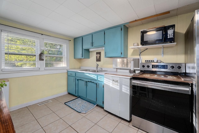 kitchen with blue cabinetry, dishwasher, sink, stainless steel range with electric stovetop, and light tile patterned floors