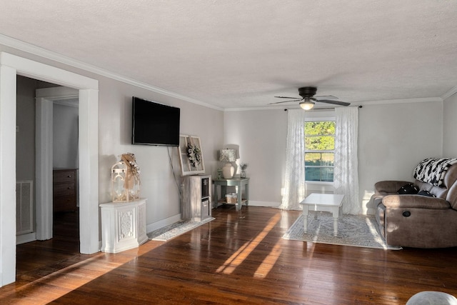 living room with a textured ceiling, crown molding, ceiling fan, and dark wood-type flooring