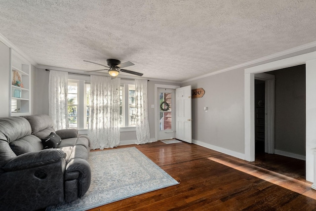 living room with built in shelves, ceiling fan, dark hardwood / wood-style flooring, and ornamental molding