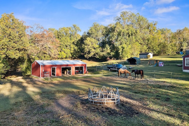 view of yard with a rural view and an outbuilding