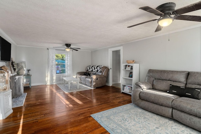 living room with ceiling fan, dark hardwood / wood-style flooring, ornamental molding, and a textured ceiling