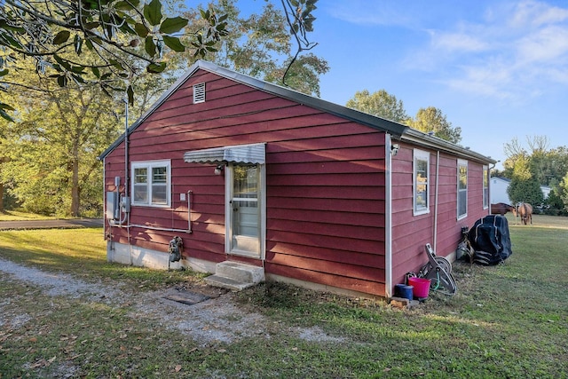 view of side of property with a yard