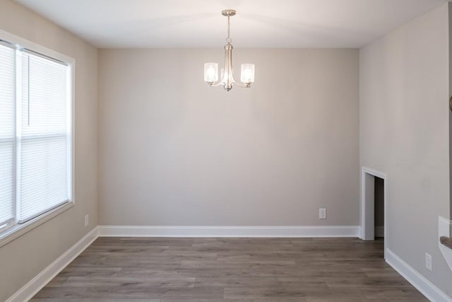 interior space with hardwood / wood-style floors and an inviting chandelier