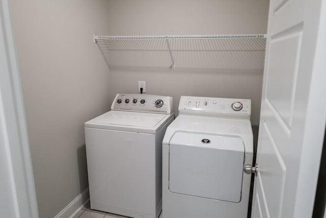 washroom with separate washer and dryer and light tile patterned floors