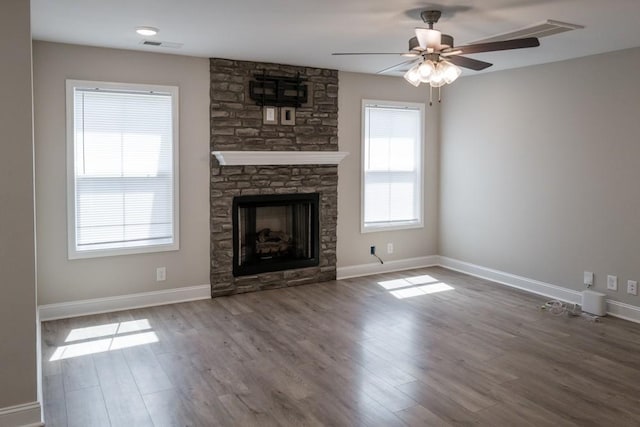 unfurnished living room featuring a fireplace, hardwood / wood-style floors, and ceiling fan