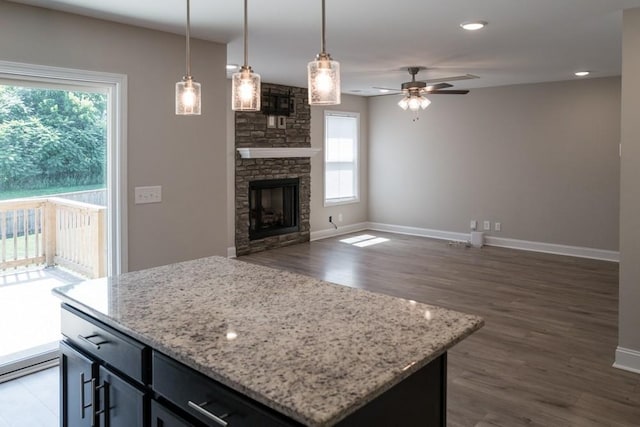 kitchen with a healthy amount of sunlight, a center island, and pendant lighting