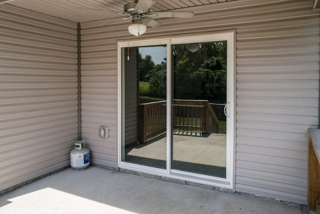 entrance to property featuring a patio area and ceiling fan