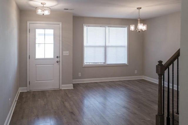 entryway featuring dark hardwood / wood-style floors and an inviting chandelier