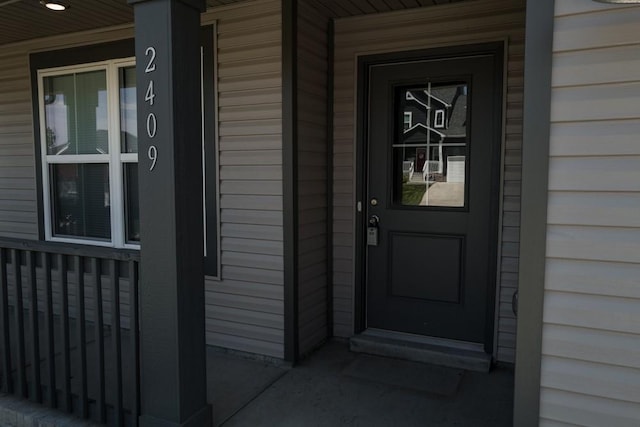 view of exterior entry with a porch