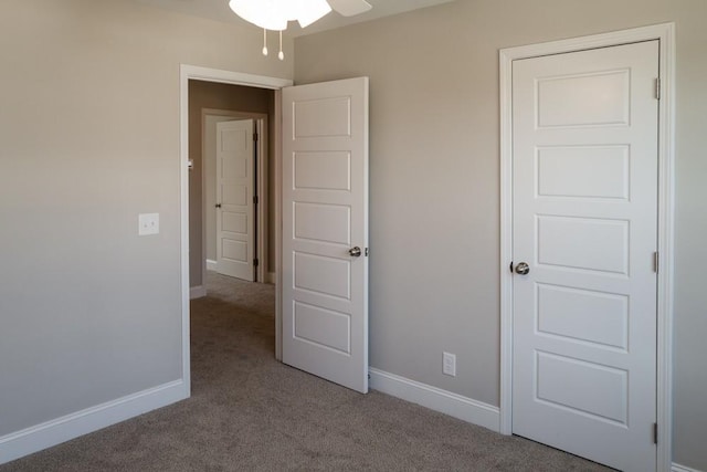 unfurnished bedroom featuring light carpet and ceiling fan