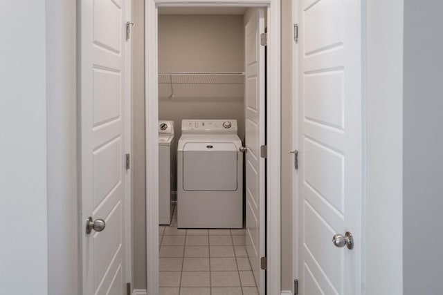 laundry area featuring light tile patterned floors and independent washer and dryer