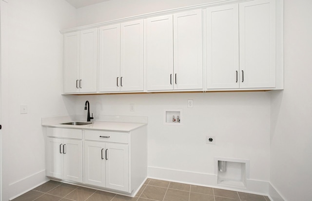 laundry area with cabinets, electric dryer hookup, sink, hookup for a washing machine, and light tile patterned floors