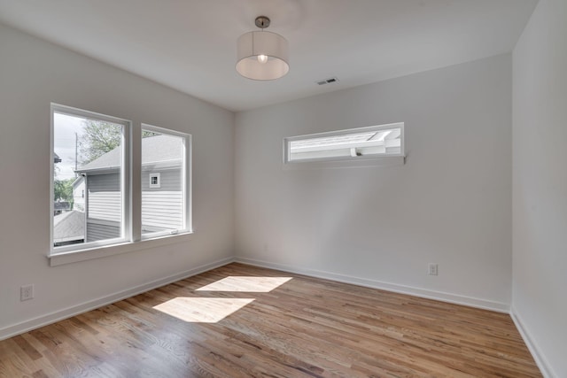 spare room featuring light hardwood / wood-style flooring