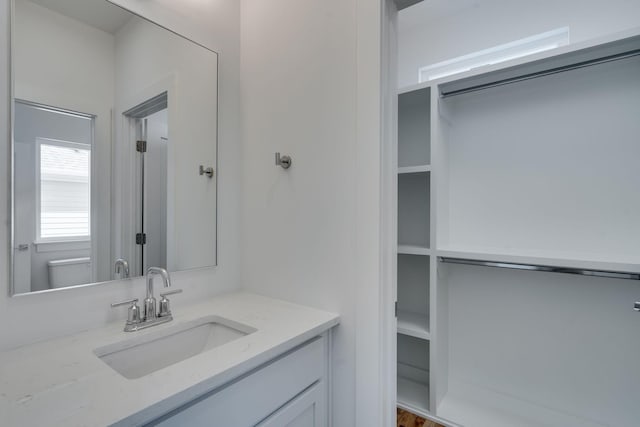 bathroom featuring vanity and toilet