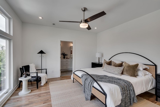 bedroom with light hardwood / wood-style floors, ceiling fan, and ensuite bathroom