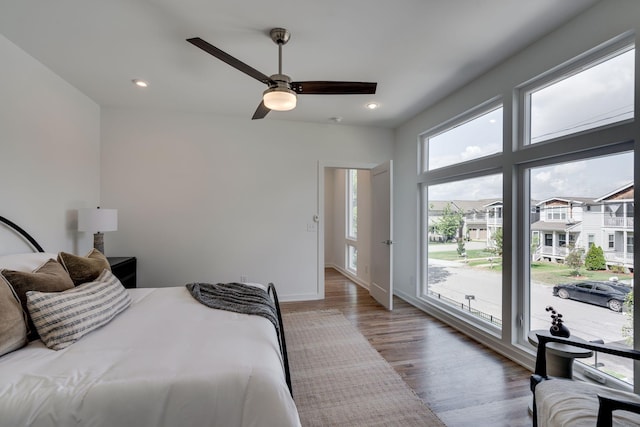 bedroom with ceiling fan, access to exterior, and hardwood / wood-style floors