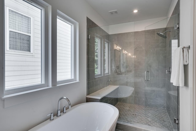 bathroom featuring separate shower and tub