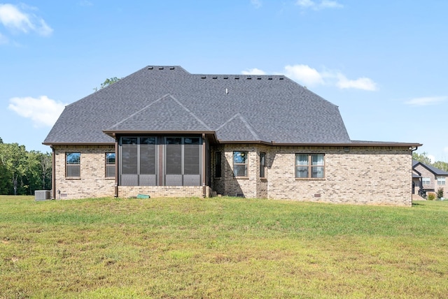 back of property featuring central AC unit, a lawn, and a sunroom