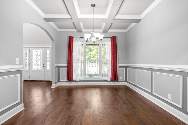 interior space with beam ceiling, coffered ceiling, an inviting chandelier, dark hardwood / wood-style flooring, and crown molding