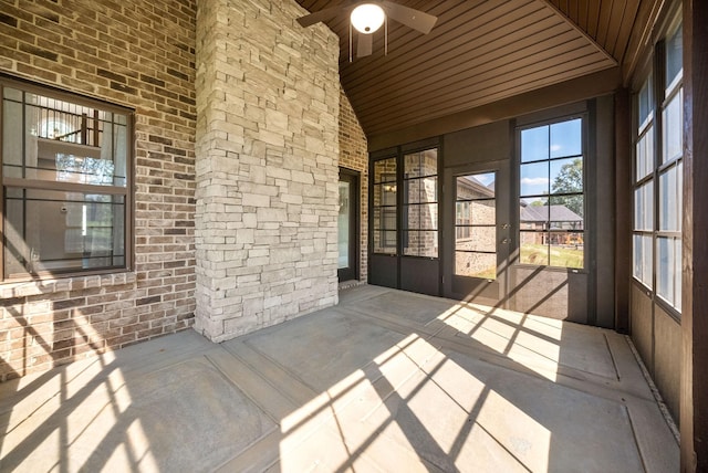 unfurnished sunroom featuring ceiling fan, wooden ceiling, and lofted ceiling