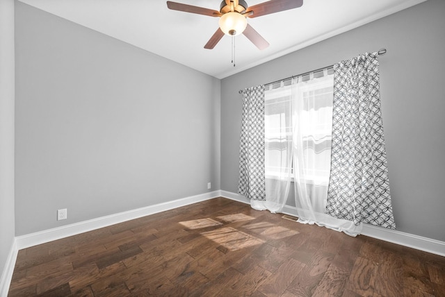 spare room with dark hardwood / wood-style floors and ceiling fan