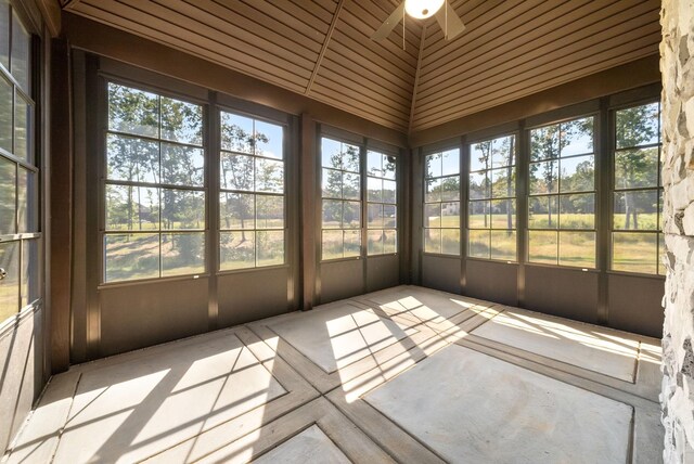 unfurnished sunroom featuring ceiling fan and wood ceiling