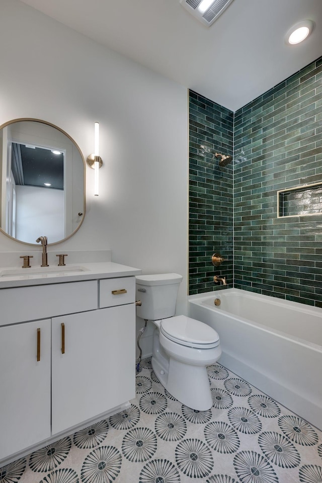 full bathroom featuring tile patterned floors, toilet, vanity, and tiled shower / bath