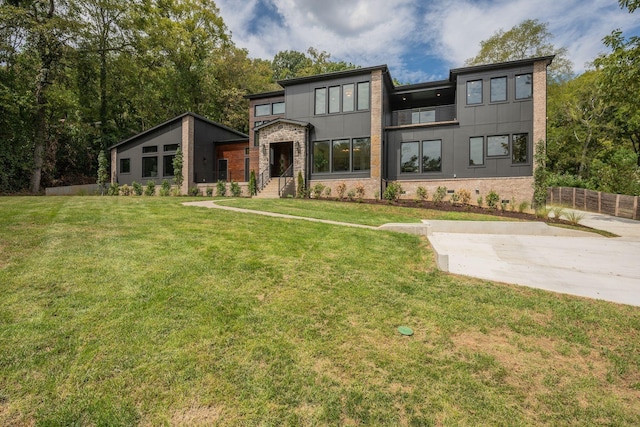 modern home featuring a front lawn