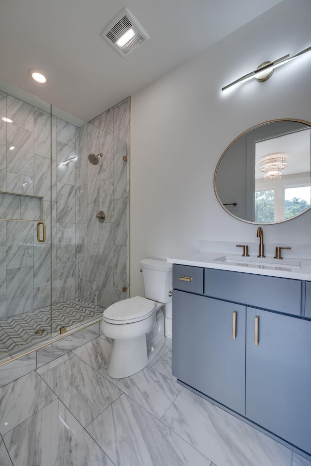 bathroom featuring vanity, an enclosed shower, and toilet