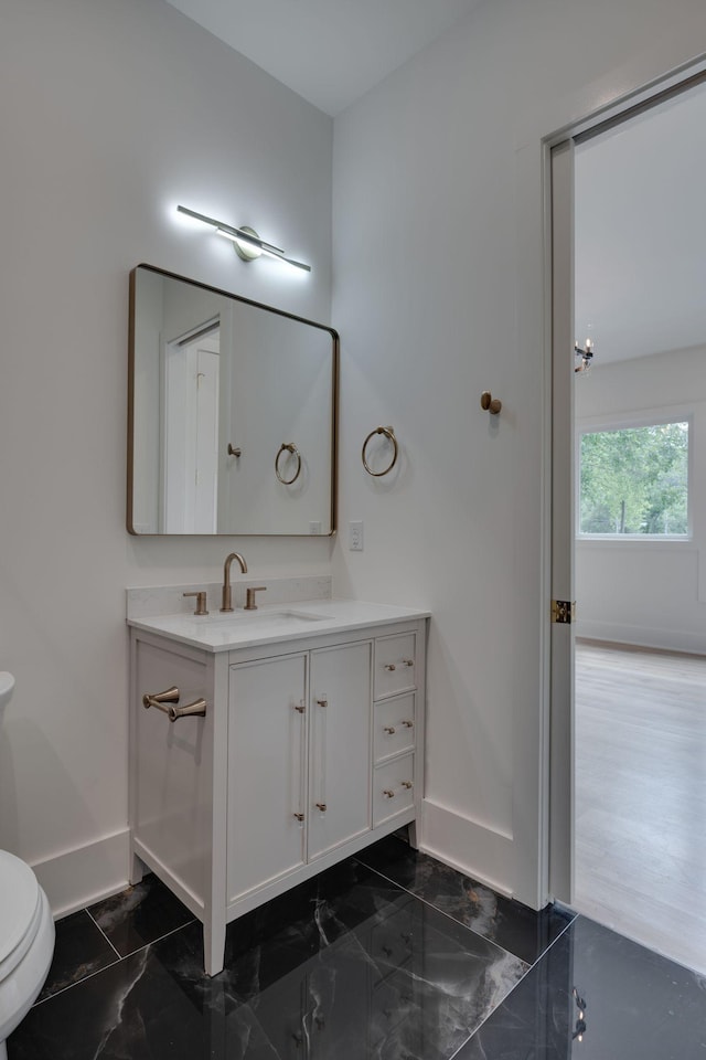 bathroom featuring vanity and toilet