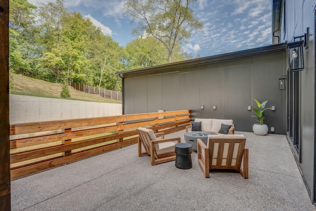 view of patio featuring an outdoor living space with a fire pit